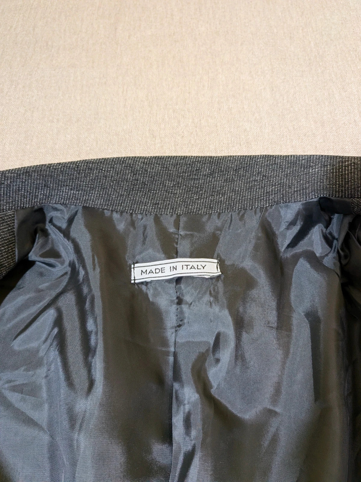 Made in Italy grey suit with three-button jacket and straight-leg trousers, soft fabric.