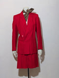 Tessuto red skirt suit with double-breasted jacket and linen-like texture.