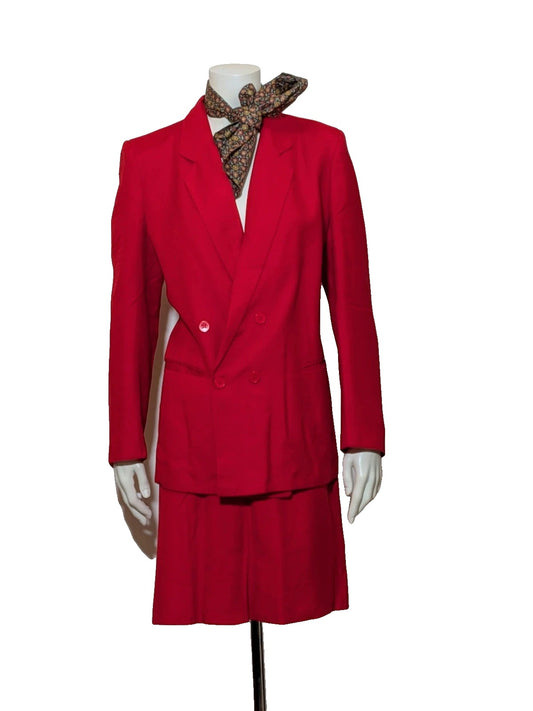Tessuto red skirt suit with double-breasted jacket and linen-like texture.