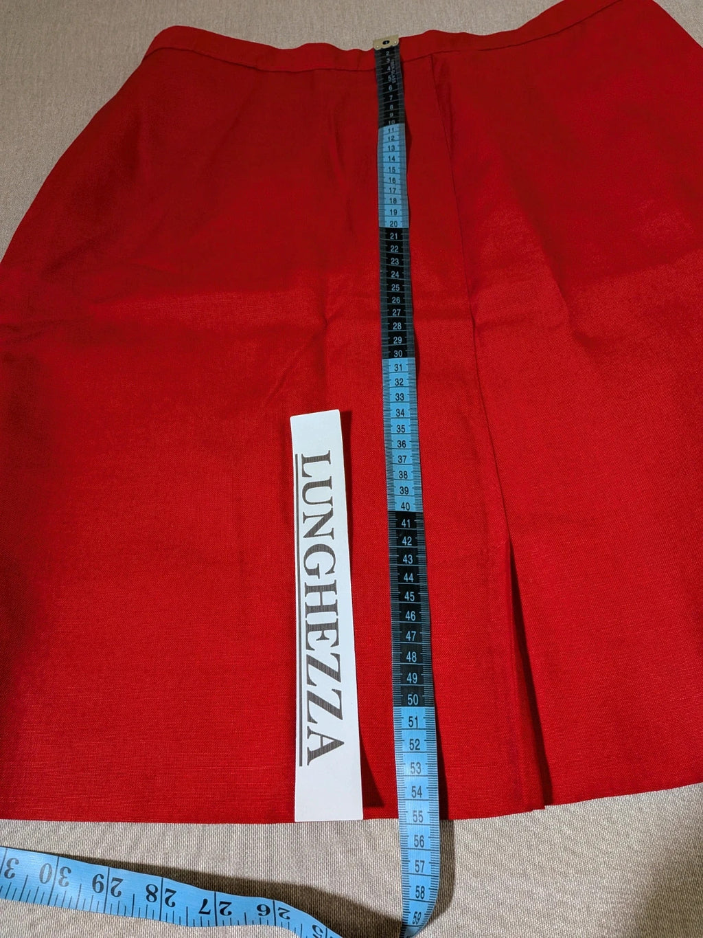 Tessuto red skirt suit with double-breasted jacket and linen-like texture.