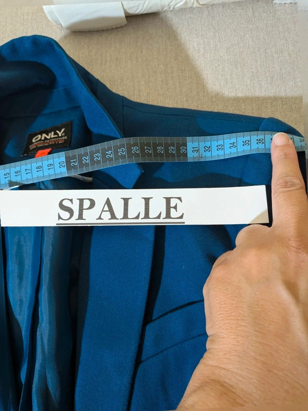 ONLY navy blazer with single-button closure and faux front pockets, modern fitted cut.