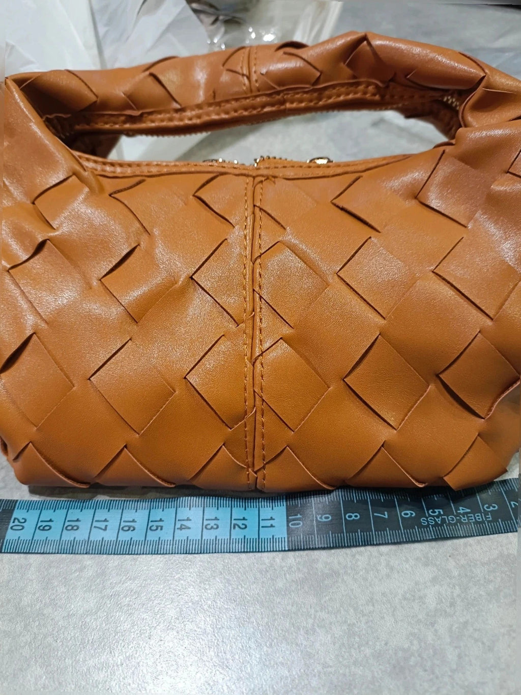 Pelle brown handbag with gold crossbody strap and textured PU leather.