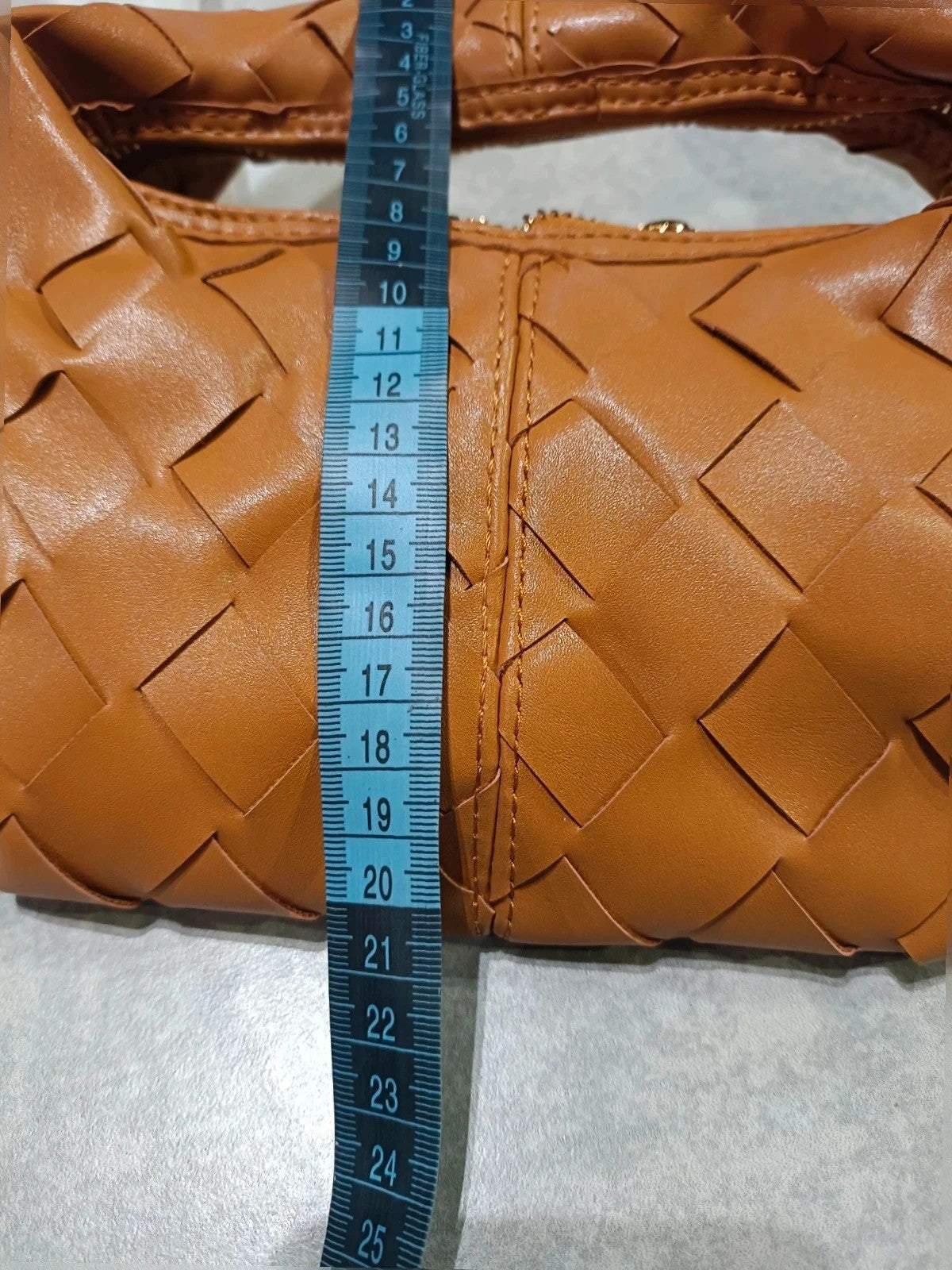 Pelle brown handbag with gold crossbody strap and textured PU leather.