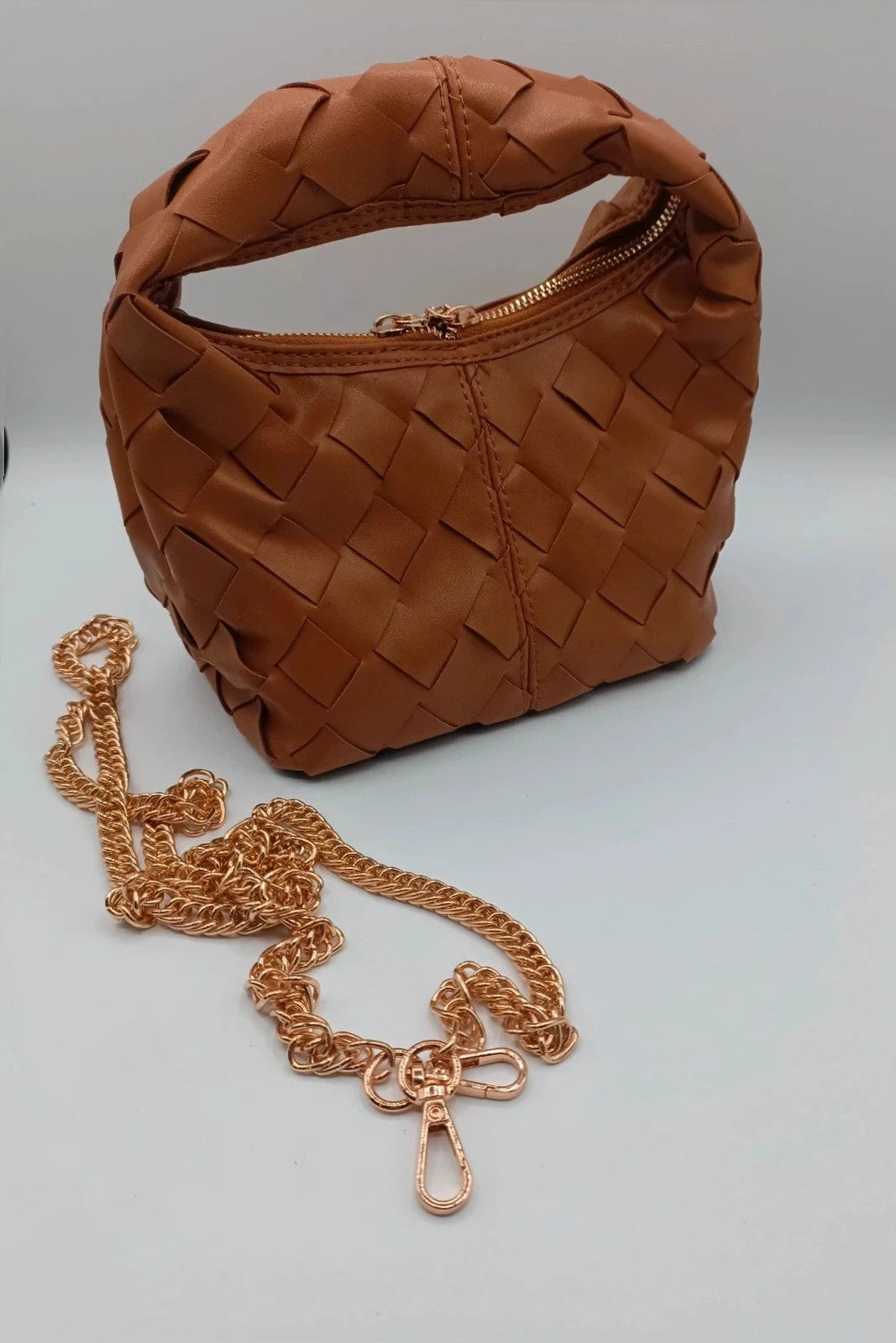 Pelle brown handbag with gold crossbody strap and textured PU leather.