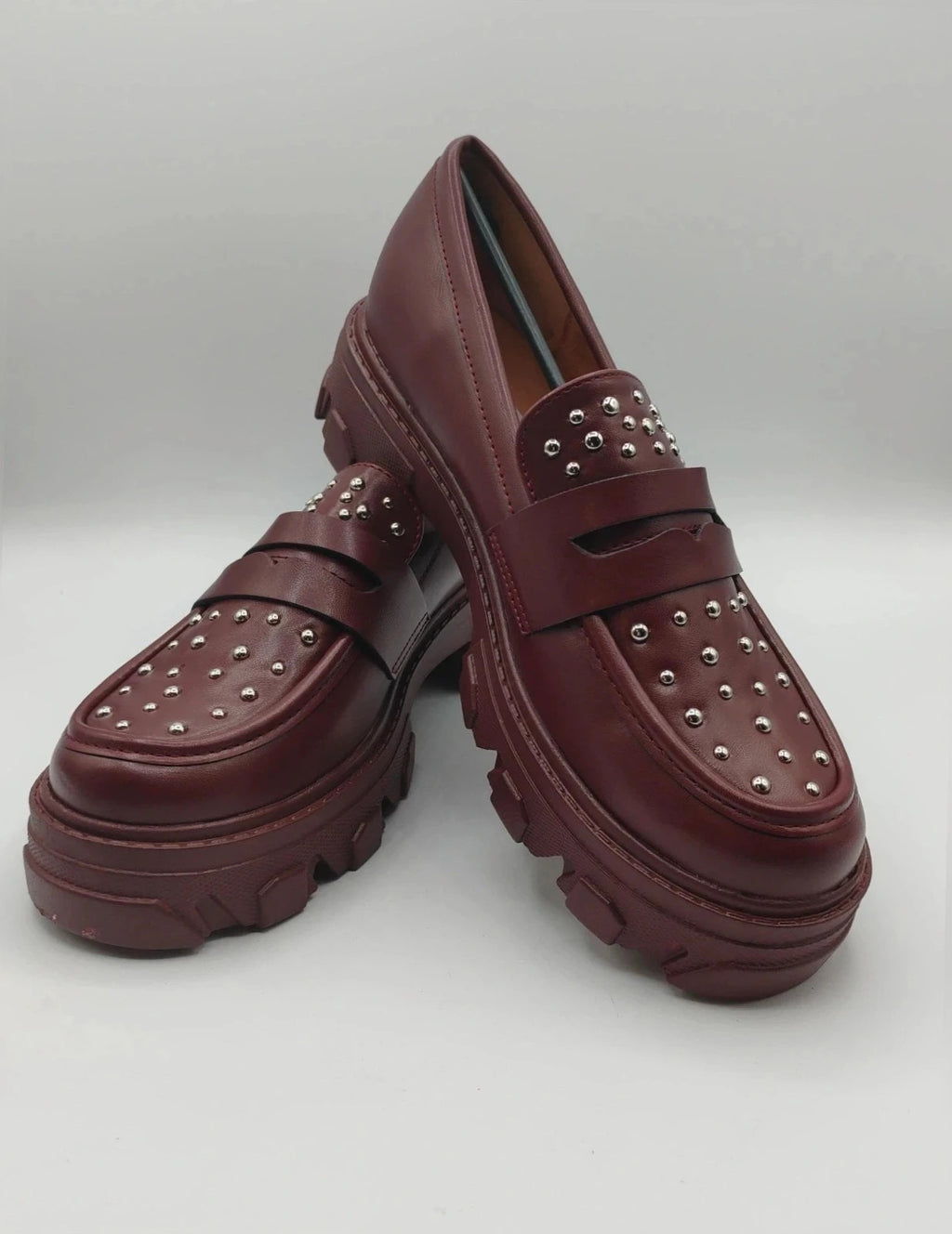 Mocassino burgundy shoes with high sole and sleek design.