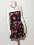 Artigli black linen maxi dress with floral pattern in pink and burgundy, strapless design.