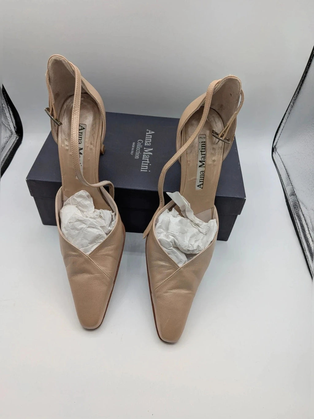 Anna Martini beige heels with satin finish, pointed toe, and adjustable ankle strap.