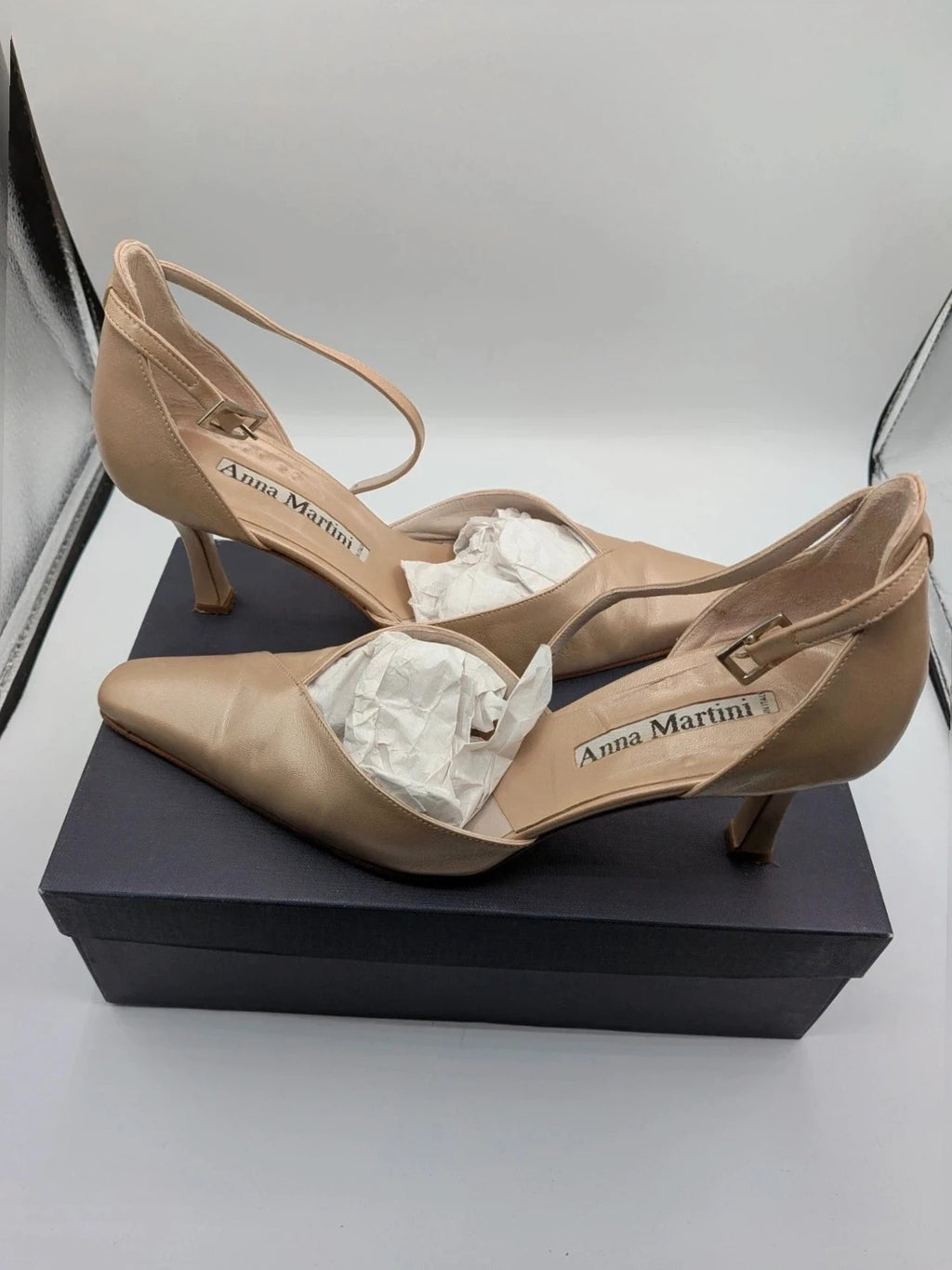 Anna Martini beige heels with satin finish, pointed toe, and adjustable ankle strap.