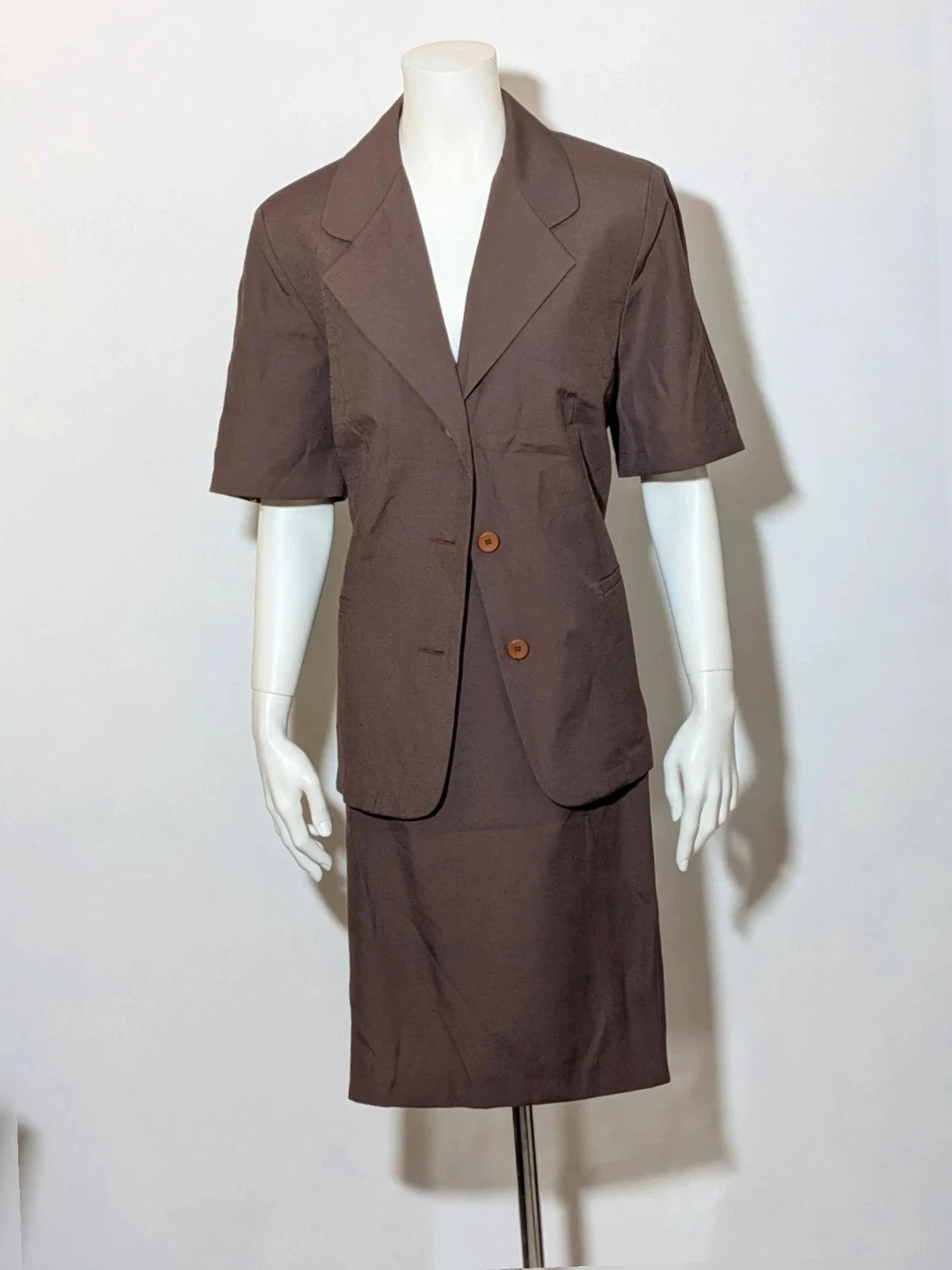 Blazer brown skirt suit with short sleeves, natural fabric texture, vintage style.