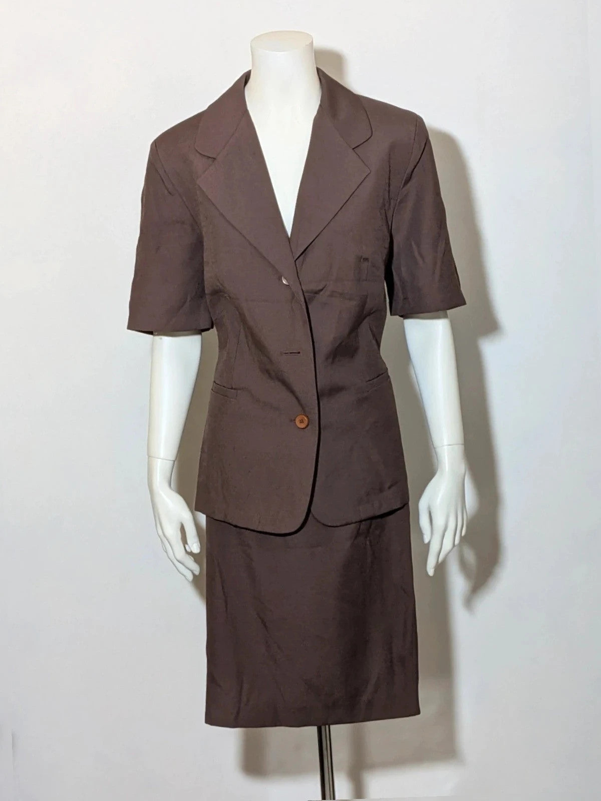 Blazer brown skirt suit with short sleeves, natural fabric texture, vintage style.
