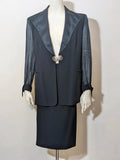 Blazer black skirt suit with navy satin lapels and sheer chiffon sleeves, jeweled clasp detail.