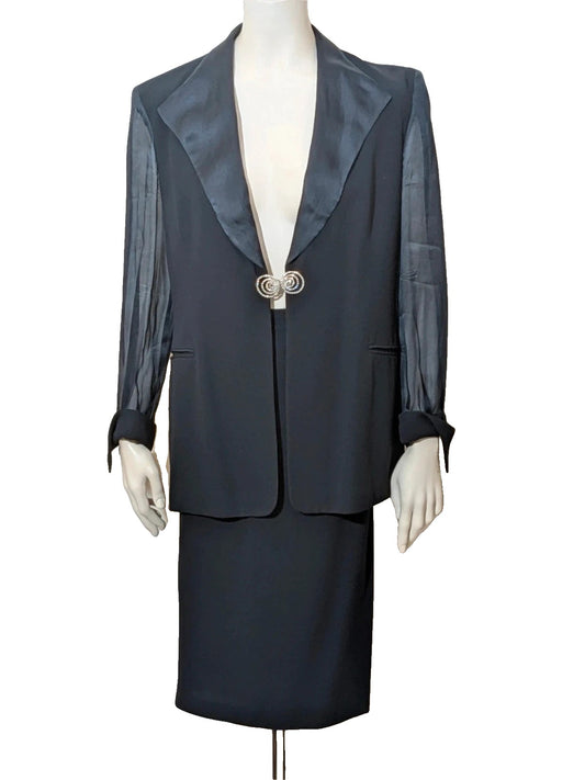 Blazer black skirt suit with navy satin lapels and sheer chiffon sleeves, jeweled clasp detail.