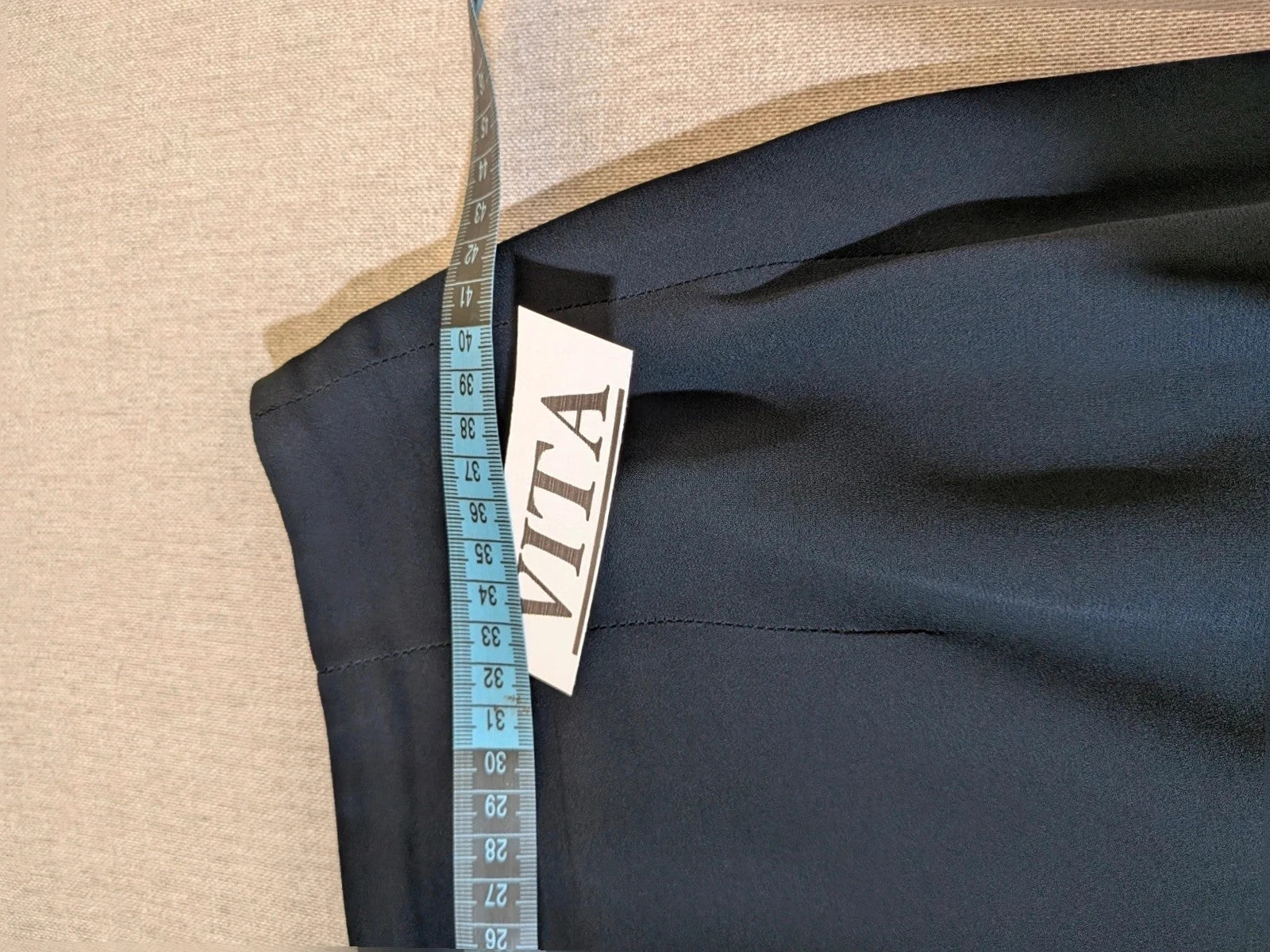 Blazer black skirt suit with navy satin lapels and sheer chiffon sleeves, jeweled clasp detail.