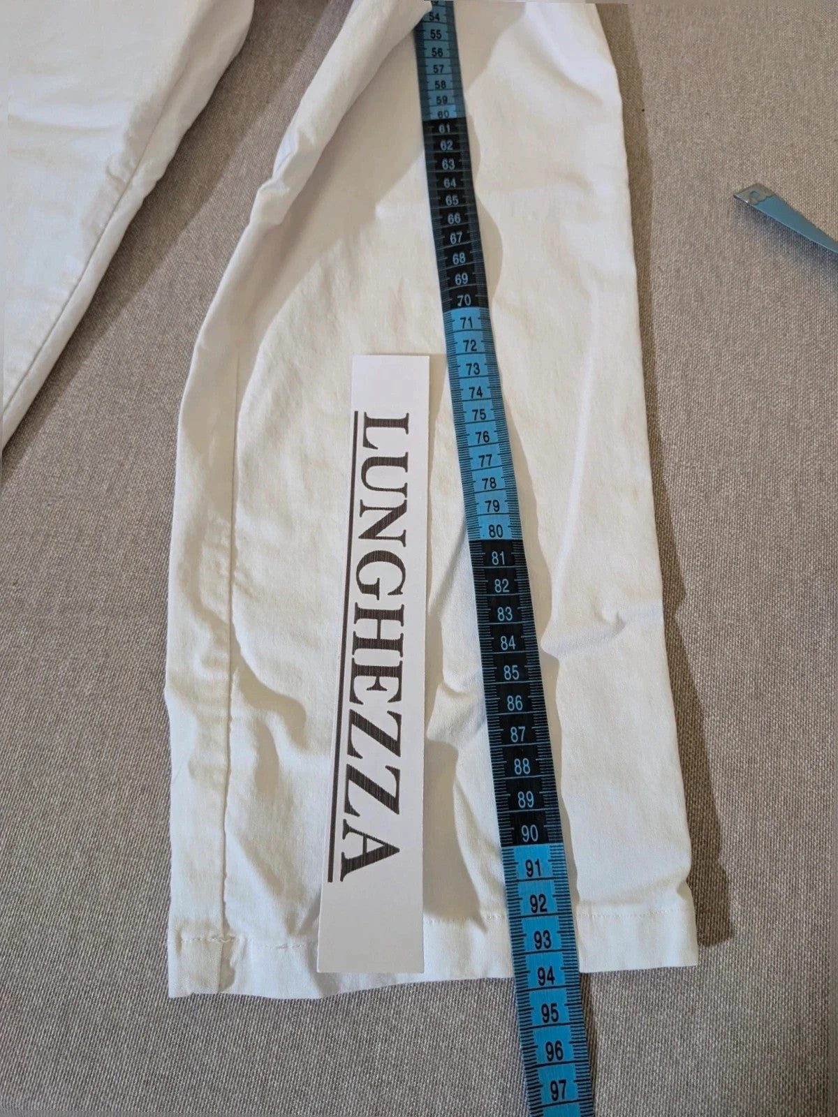 M-Made in Italy turquoise blazer suit with elegant lapel and white trousers, cotton blend.