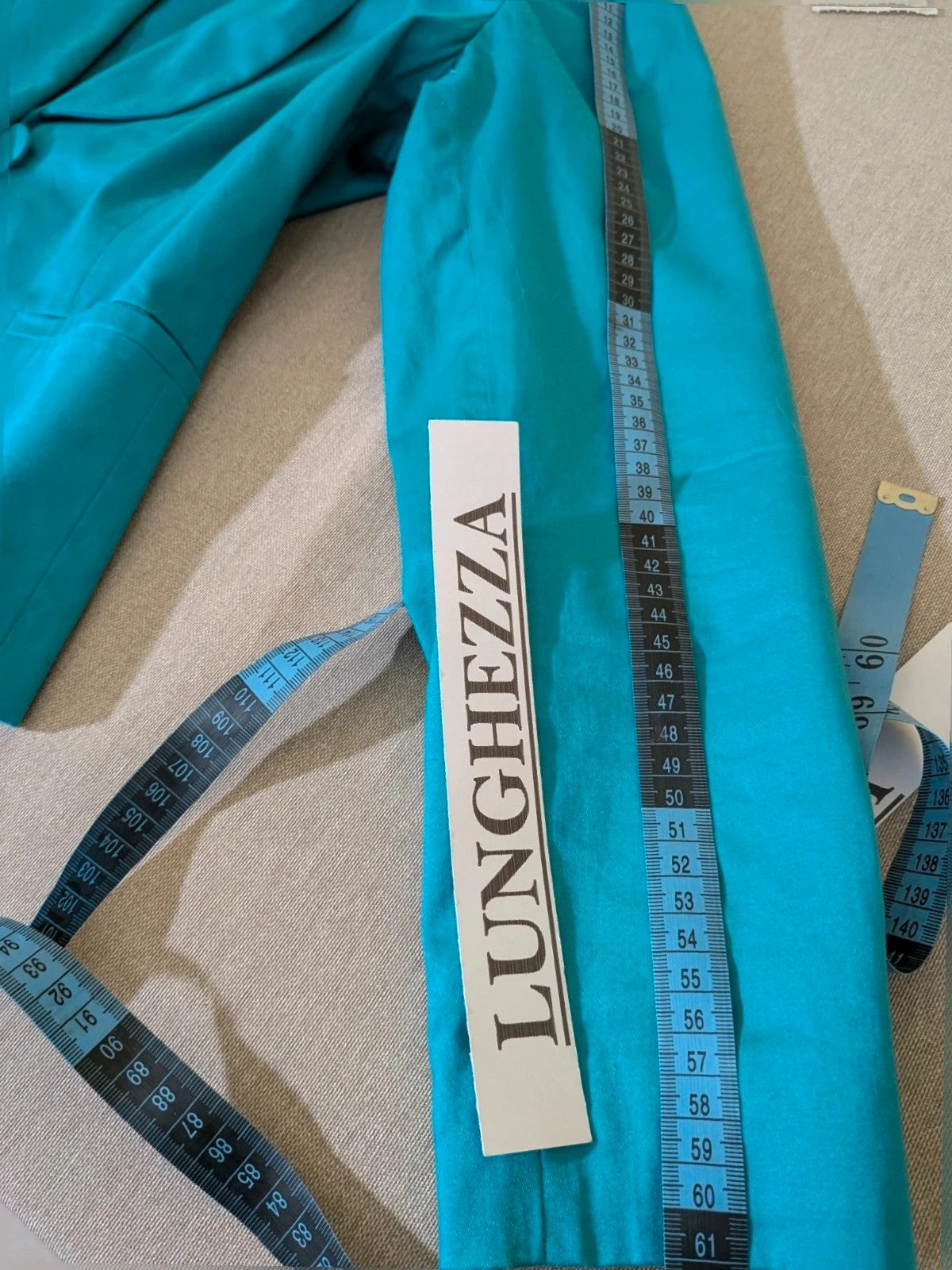 M-Made in Italy turquoise blazer suit with elegant lapel and white trousers, cotton blend.