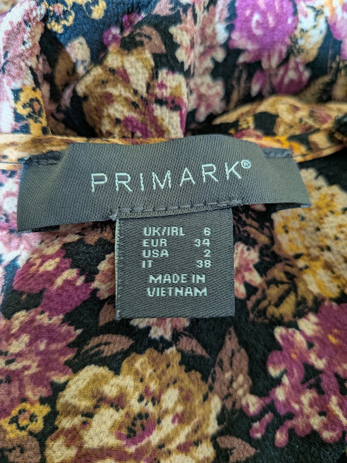 Gerry Weber multi suit with floral Primark top, draped design, and camel trousers.