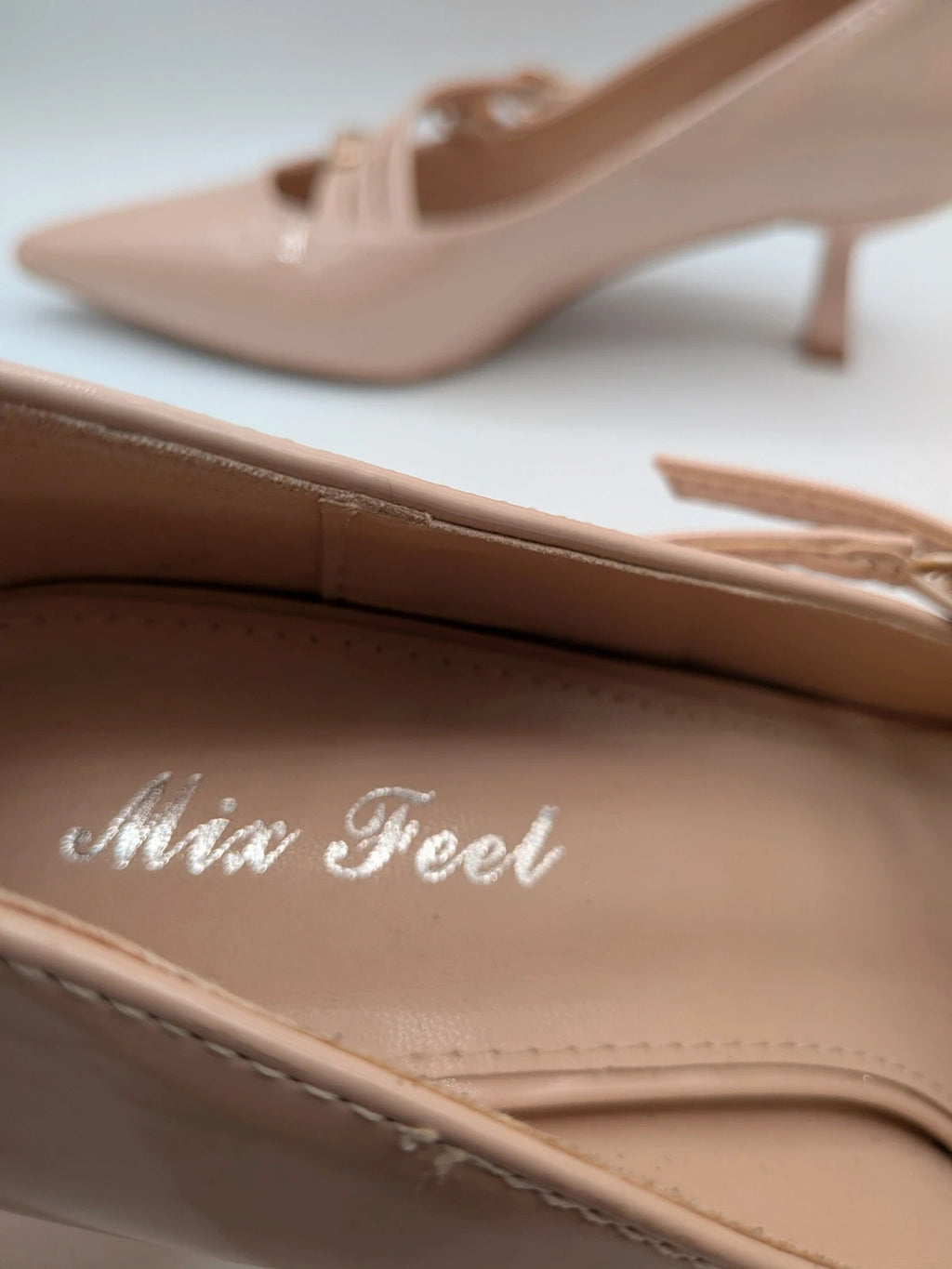 Mix Feel beige heels with pointed toe, glossy patent finish, and decorative gold buckles.