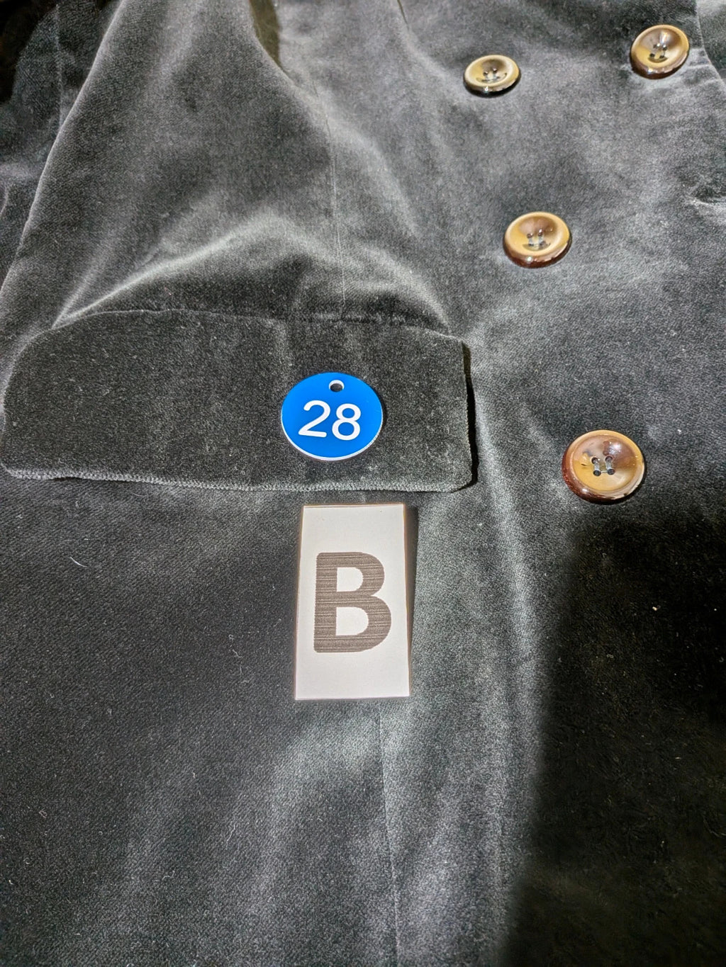 Estasy FIRENZE black double-breasted coat in soft velvet with contrast buttons and pockets.