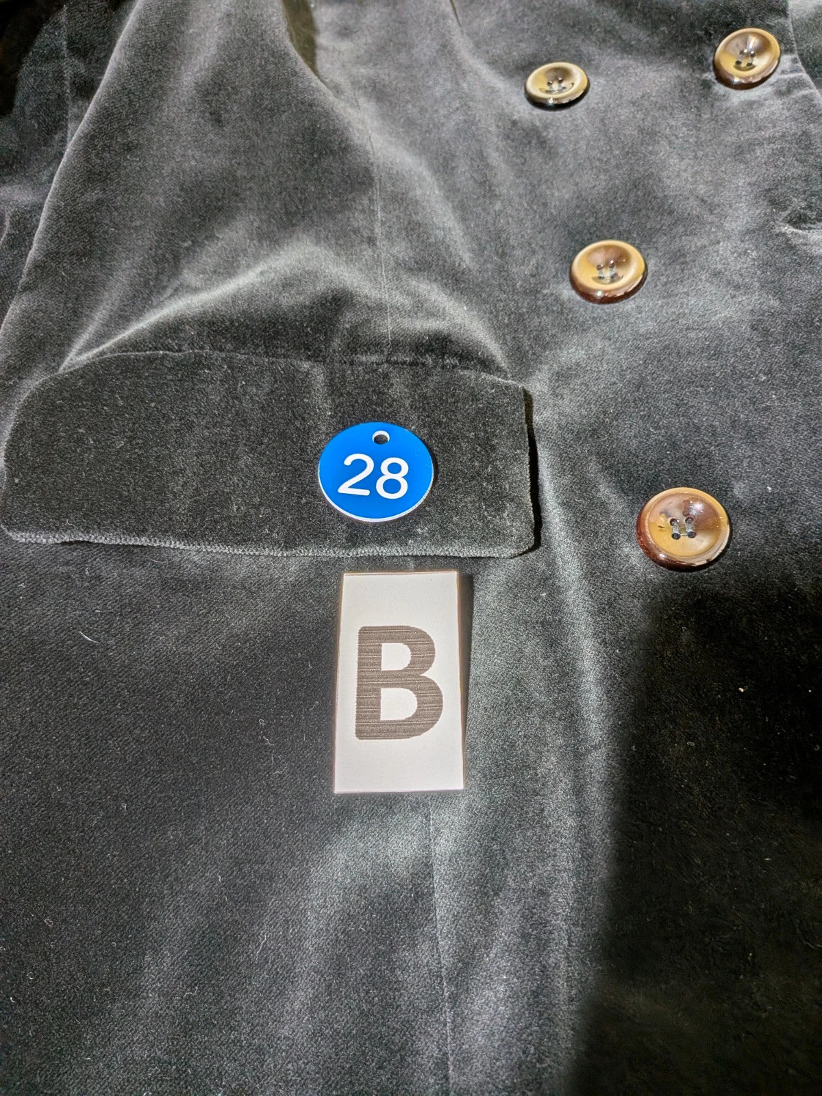 Estasy FIRENZE black double-breasted coat in soft velvet with contrast buttons and pockets.