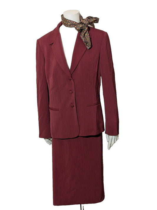 Walter Duchini burgundy skirt suit with classic lapel, three-button closure, and pencil skirt.