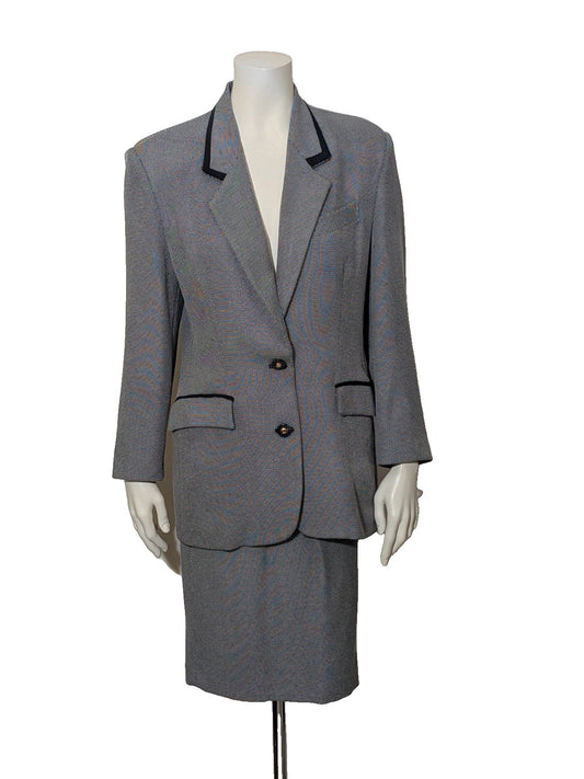 M immagine grey skirt suit with structured jacket, jewel buttons, and contrasting collar.