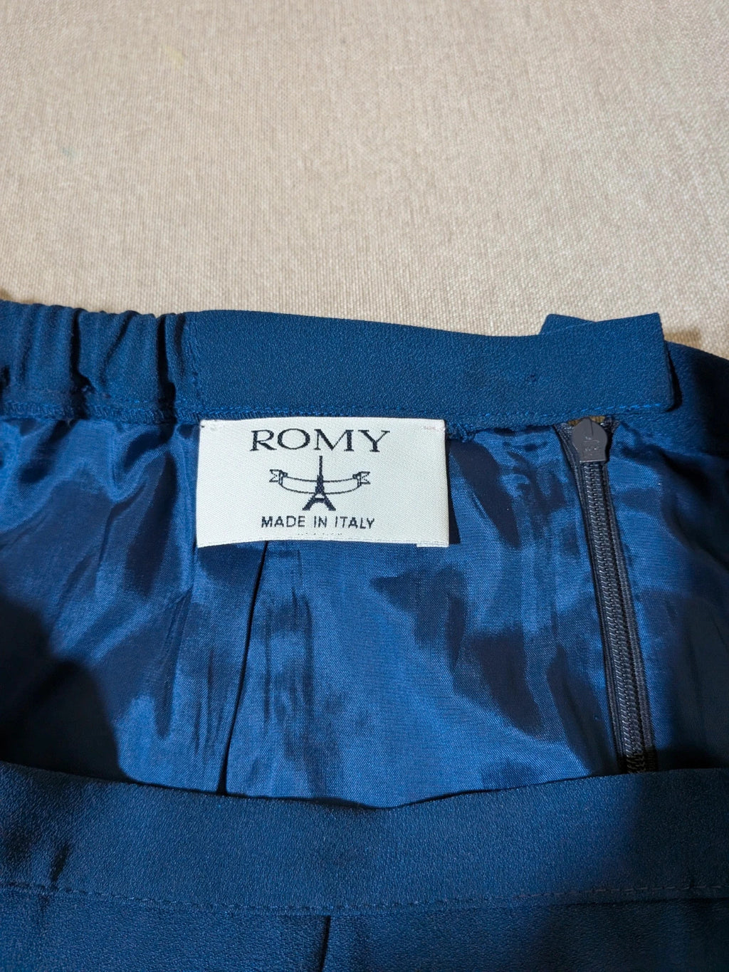 Romy blue skirt suit with classic blazer, two-button closure, and pencil skirt.