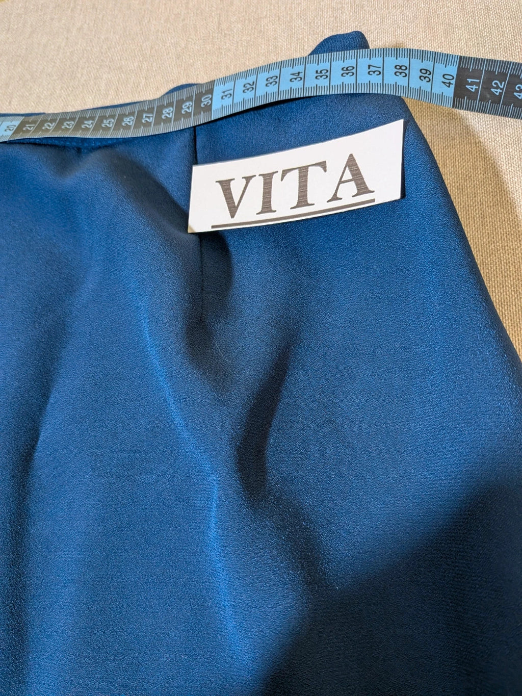 Romy blue skirt suit with classic blazer, two-button closure, and pencil skirt.