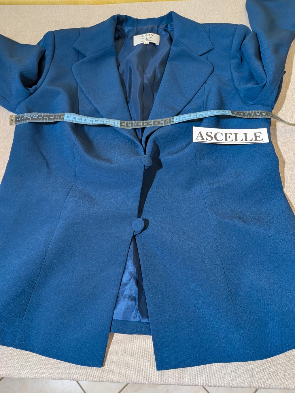 Romy blue skirt suit with classic blazer, two-button closure, and pencil skirt.