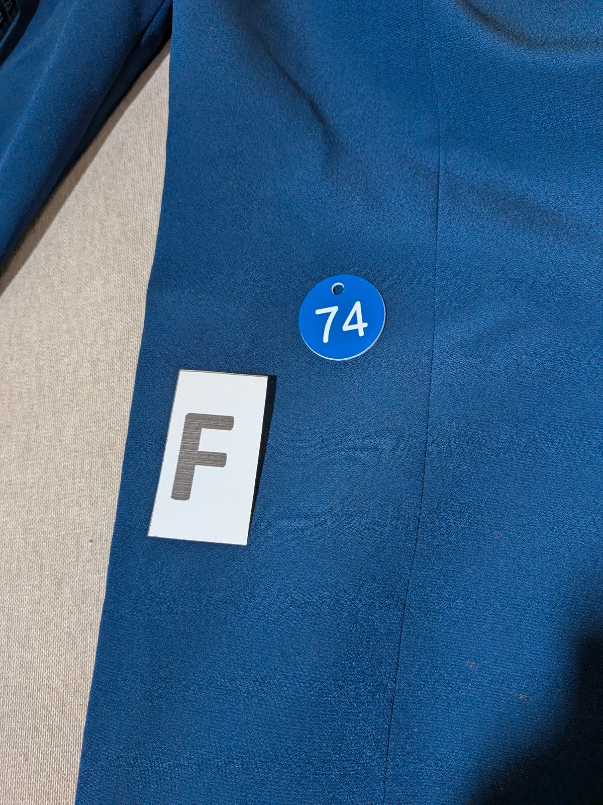 Romy blue skirt suit with classic blazer, two-button closure, and pencil skirt.