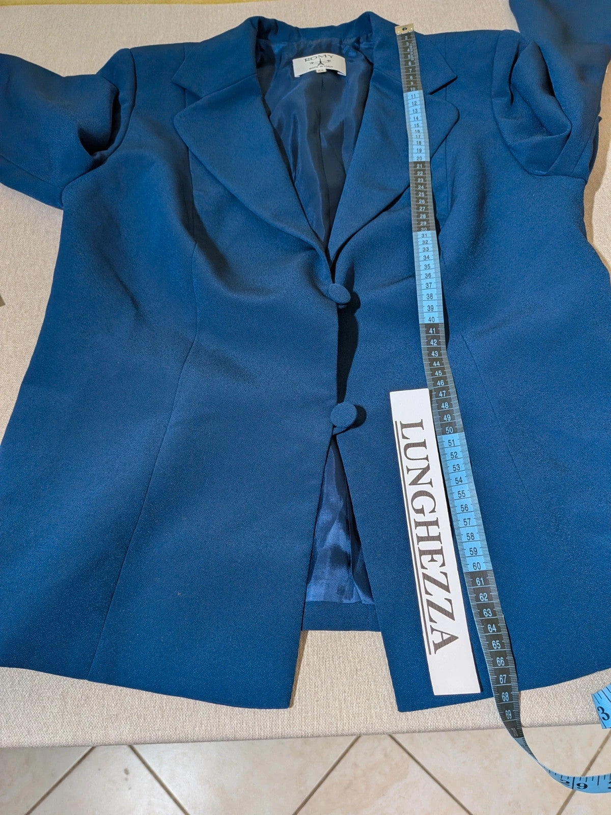 Romy blue skirt suit with classic blazer, two-button closure, and pencil skirt.
