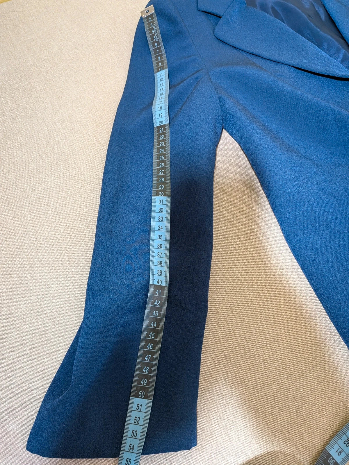 Romy blue skirt suit with classic blazer, two-button closure, and pencil skirt.
