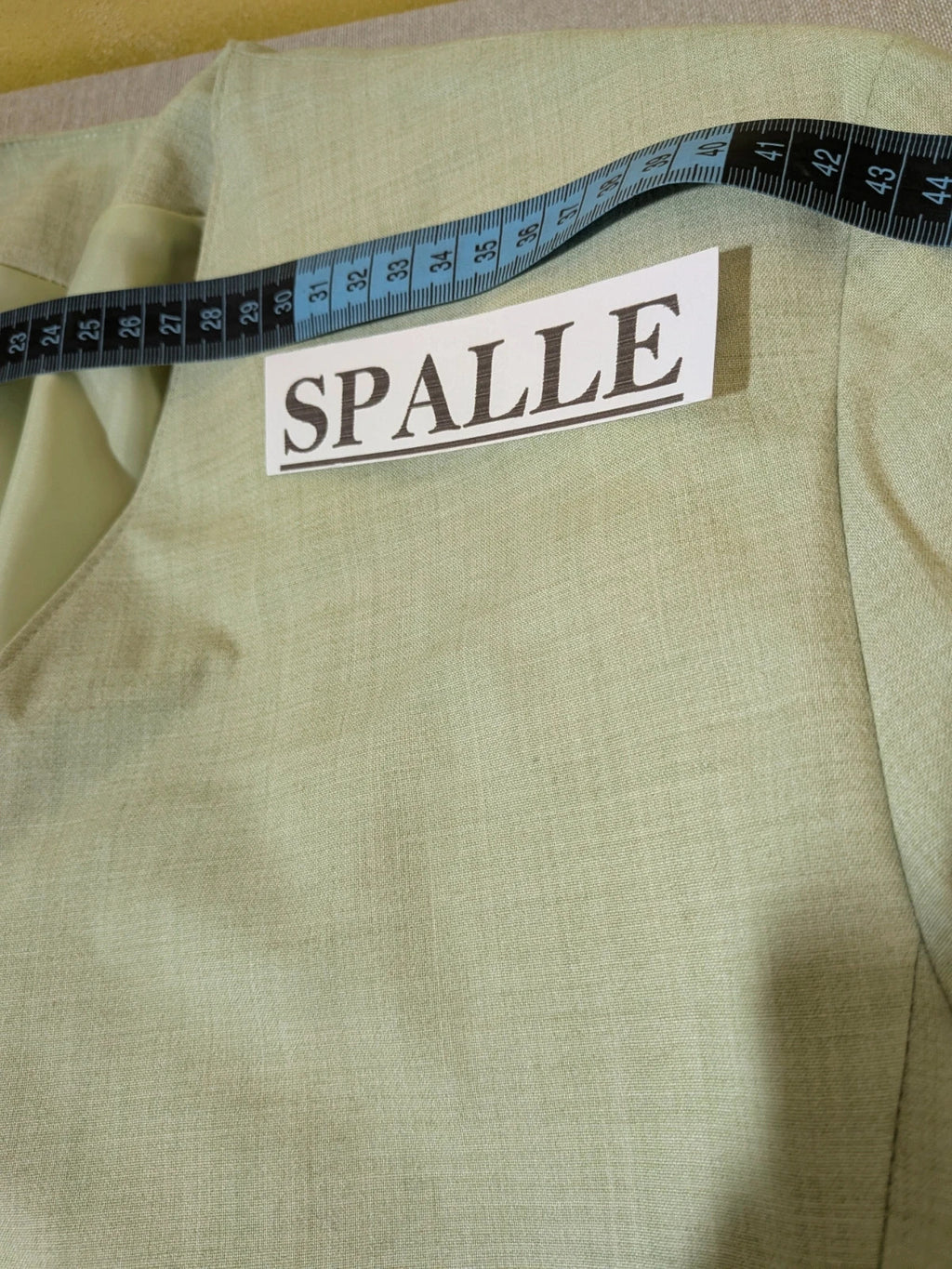 M-Made in Italy green blazer collarless design with three-button closure and front pockets.