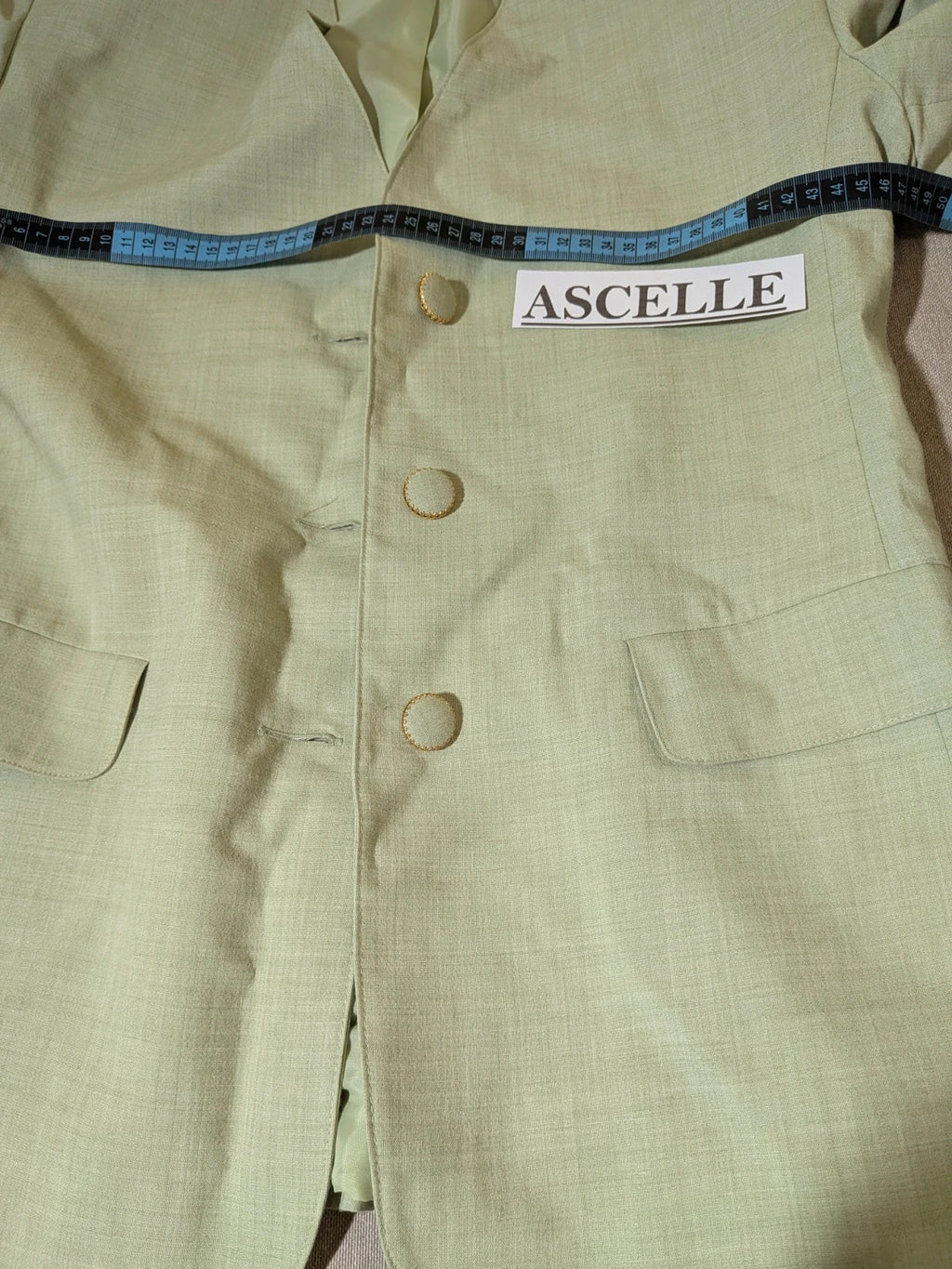 M-Made in Italy green blazer collarless design with three-button closure and front pockets.