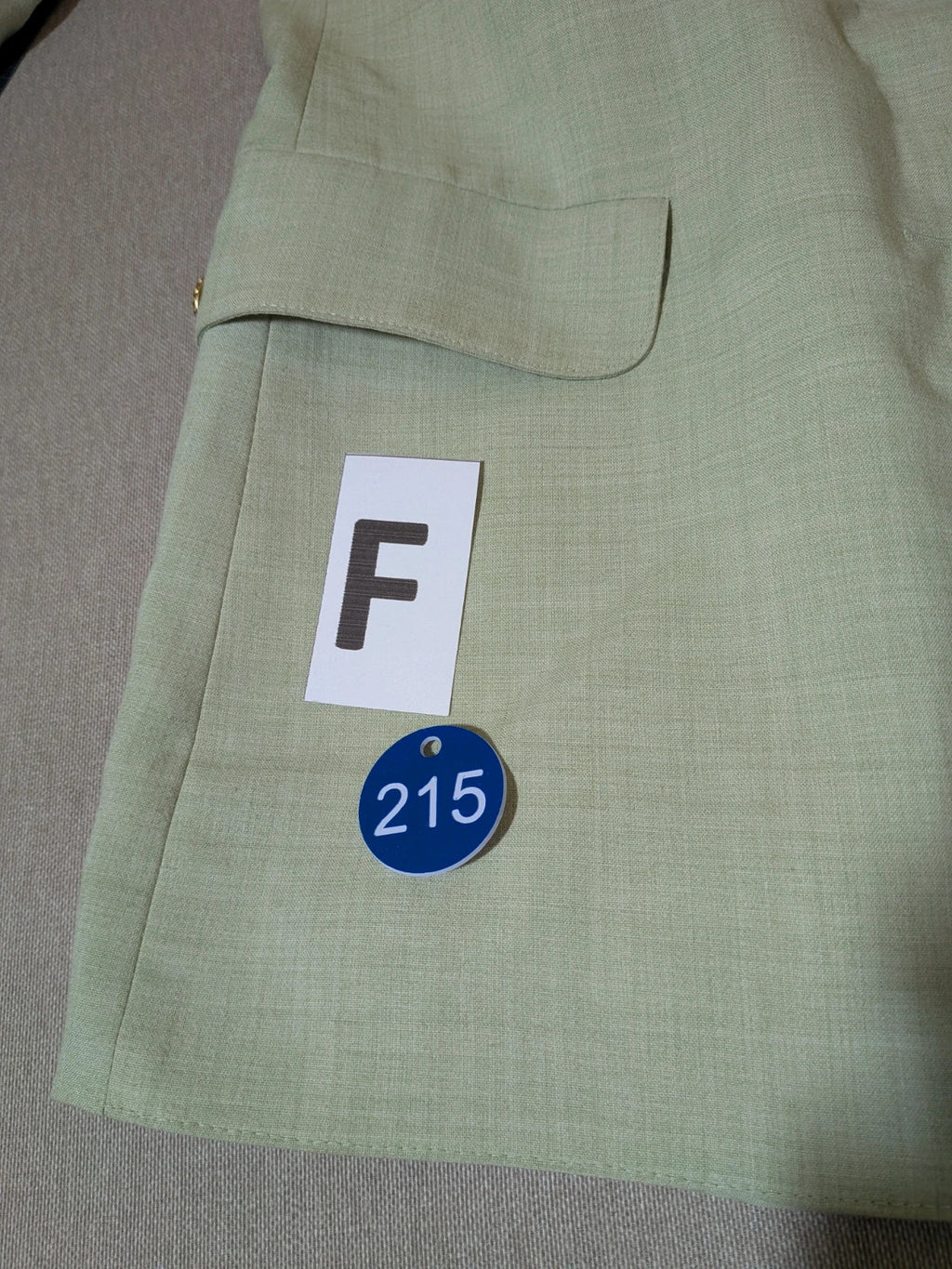 M-Made in Italy green blazer collarless design with three-button closure and front pockets.