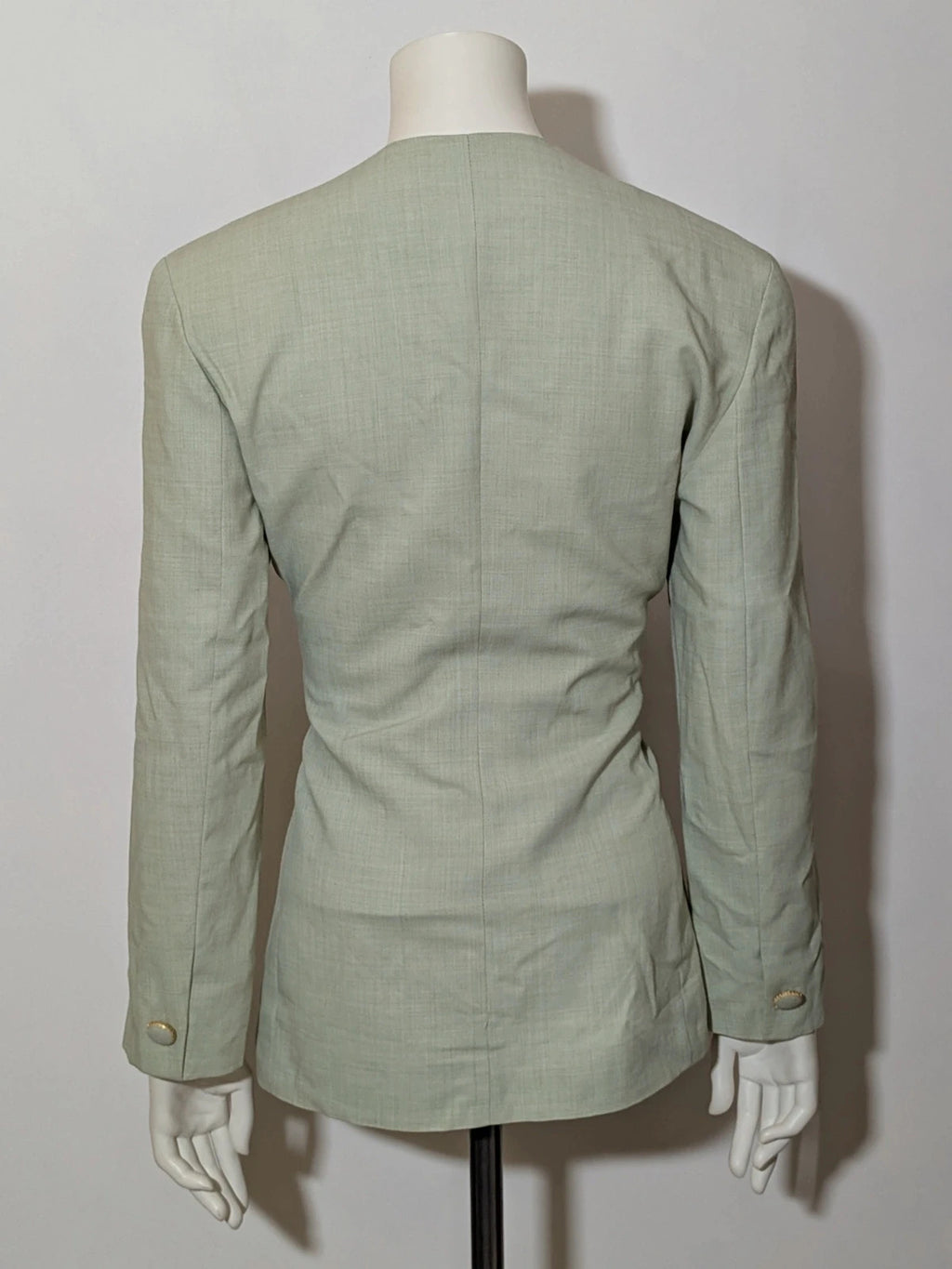 M-Made in Italy green blazer collarless design with three-button closure and front pockets.