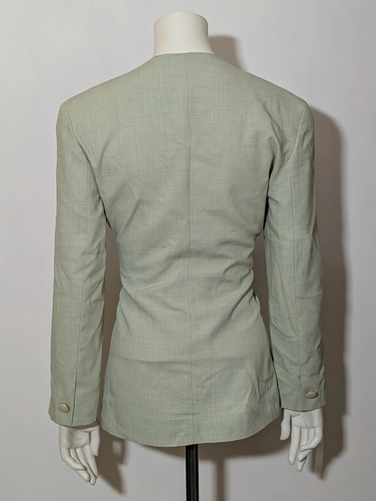 M-Made in Italy green blazer collarless design with three-button closure and front pockets.