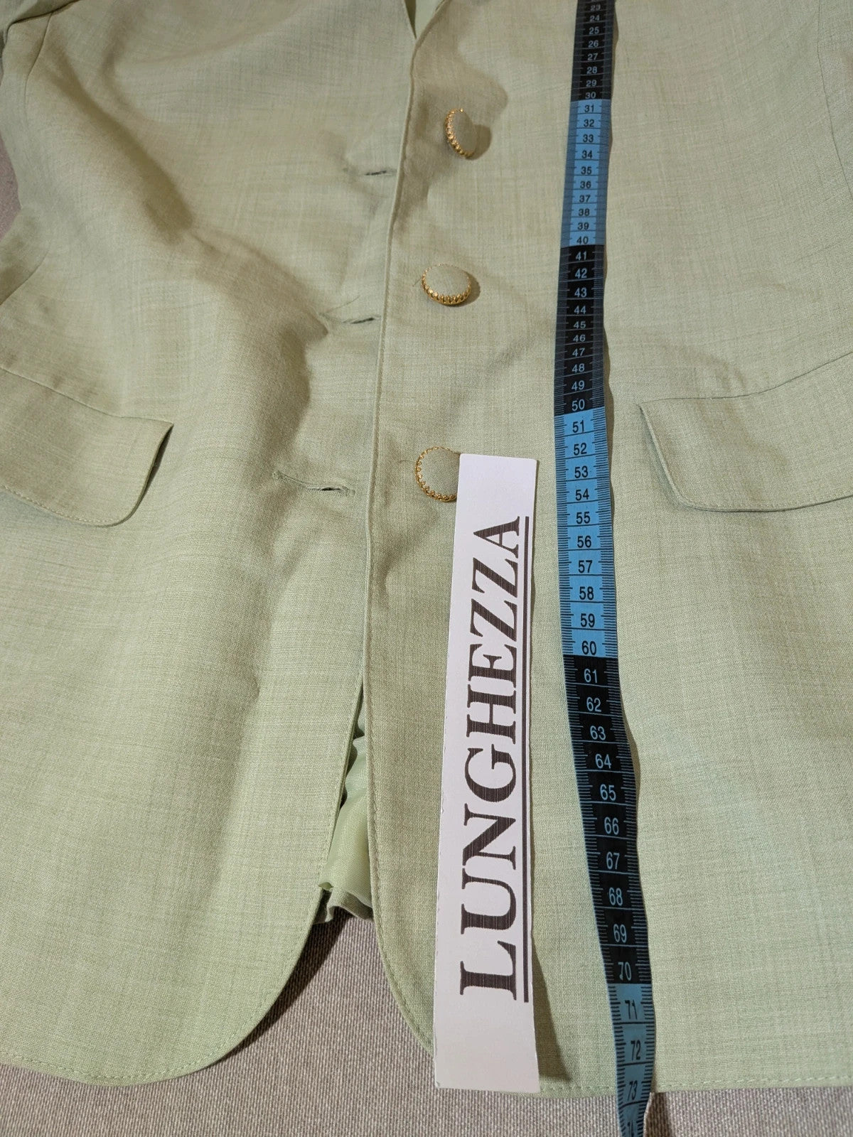 M-Made in Italy green blazer collarless design with three-button closure and front pockets.