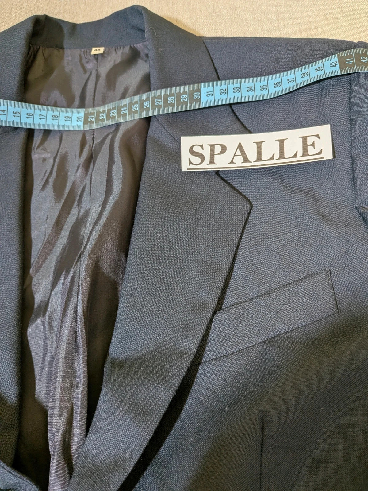 Made in Italy navy blazer suit with structured design and Pura Lana Vergine quality label.