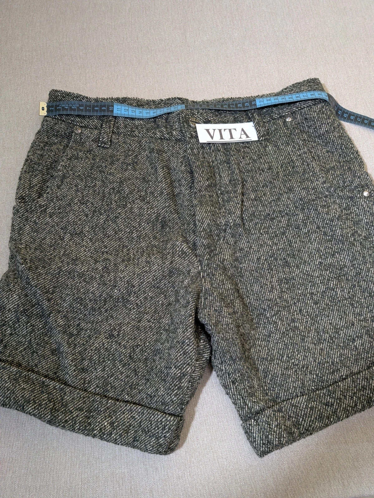 Cycle multi suit with tweed shorts and cream cropped sweater featuring distressed knit details.