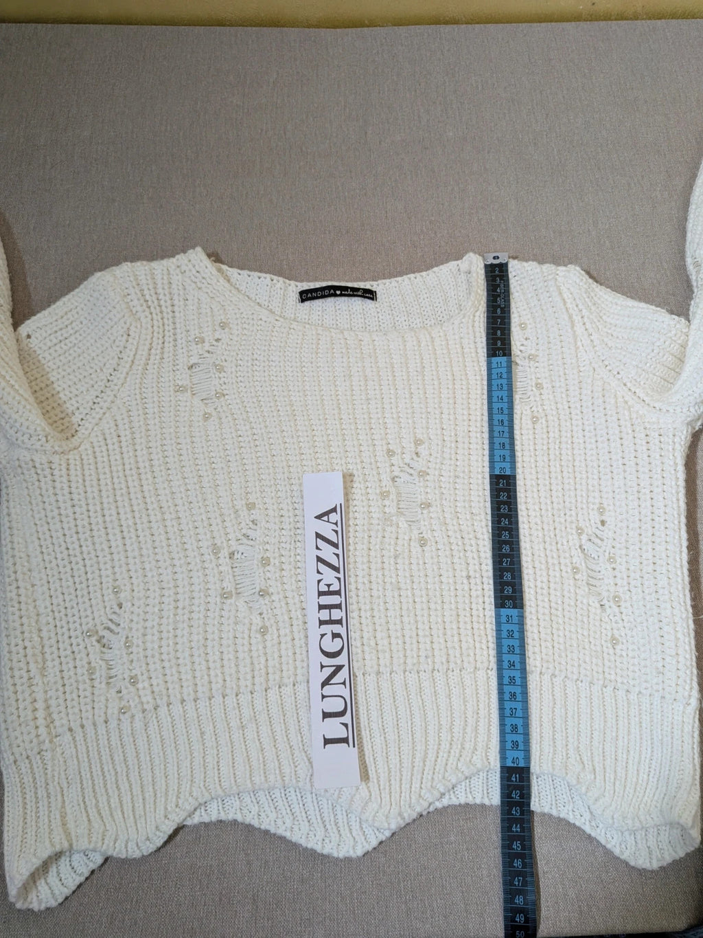 Cycle multi suit with tweed shorts and cream cropped sweater featuring distressed knit details.
