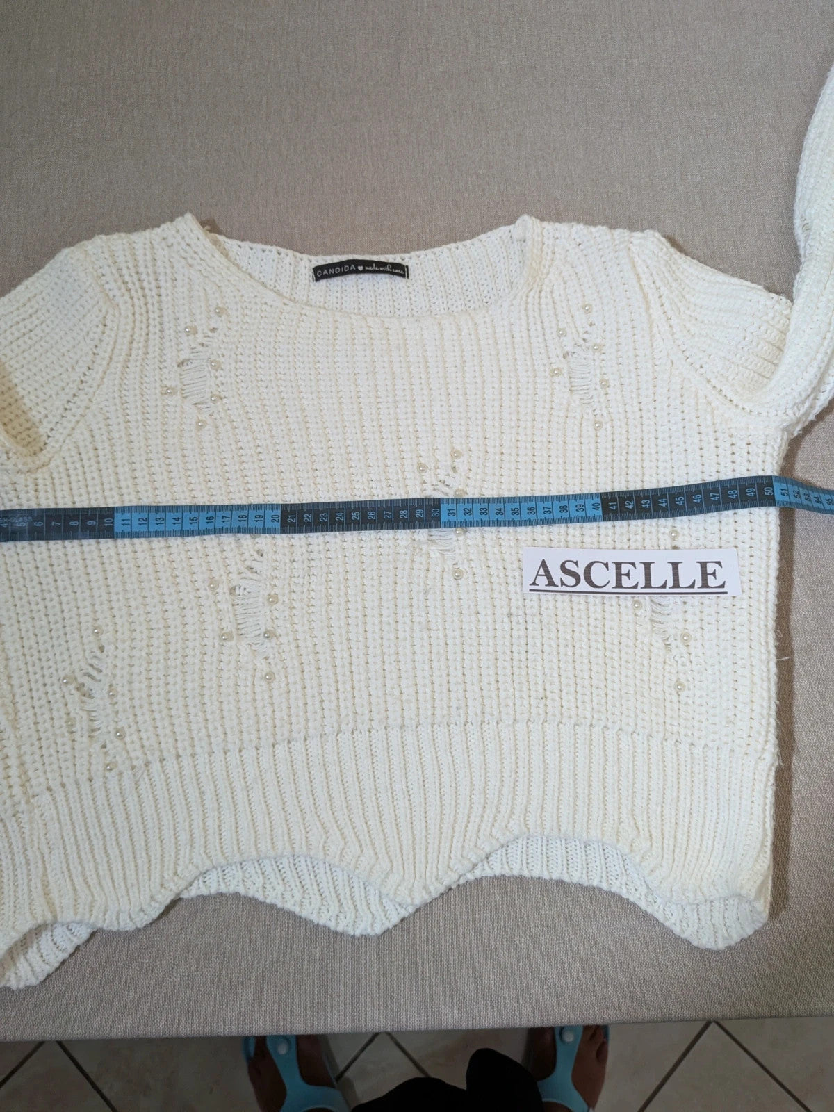 Cycle multi suit with tweed shorts and cream cropped sweater featuring distressed knit details.