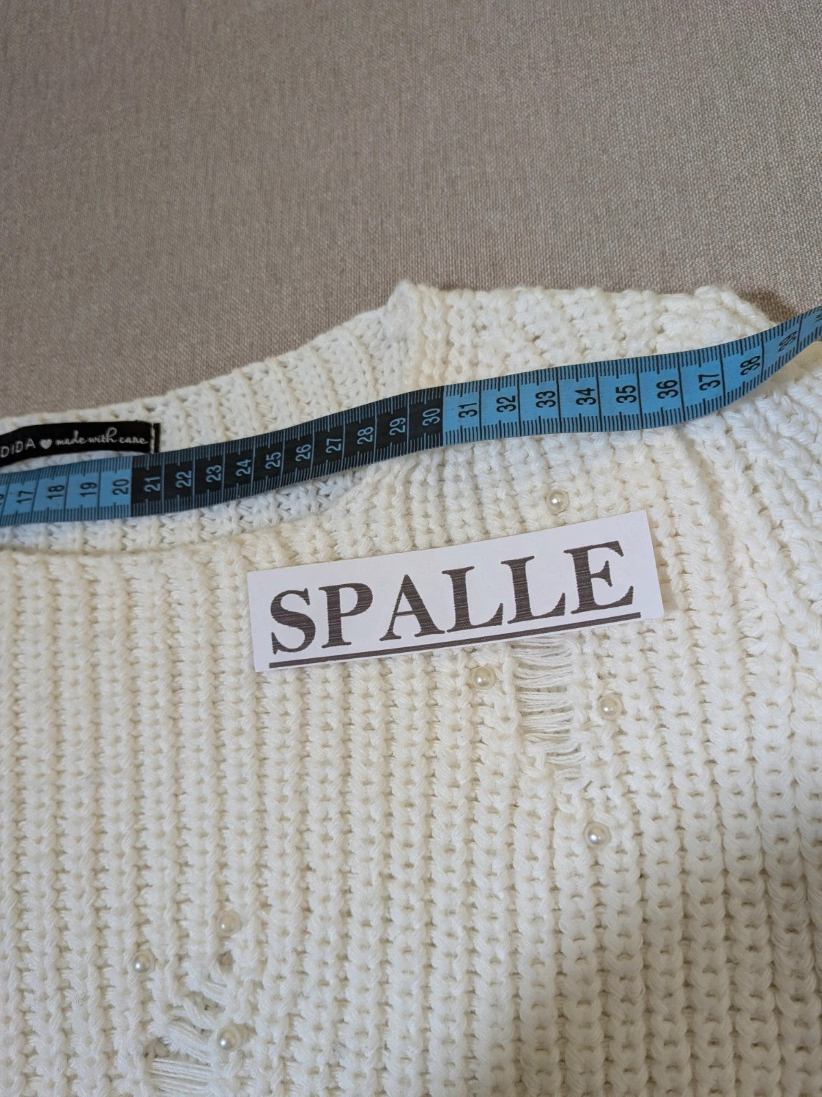 Cycle multi suit with tweed shorts and cream cropped sweater featuring distressed knit details.