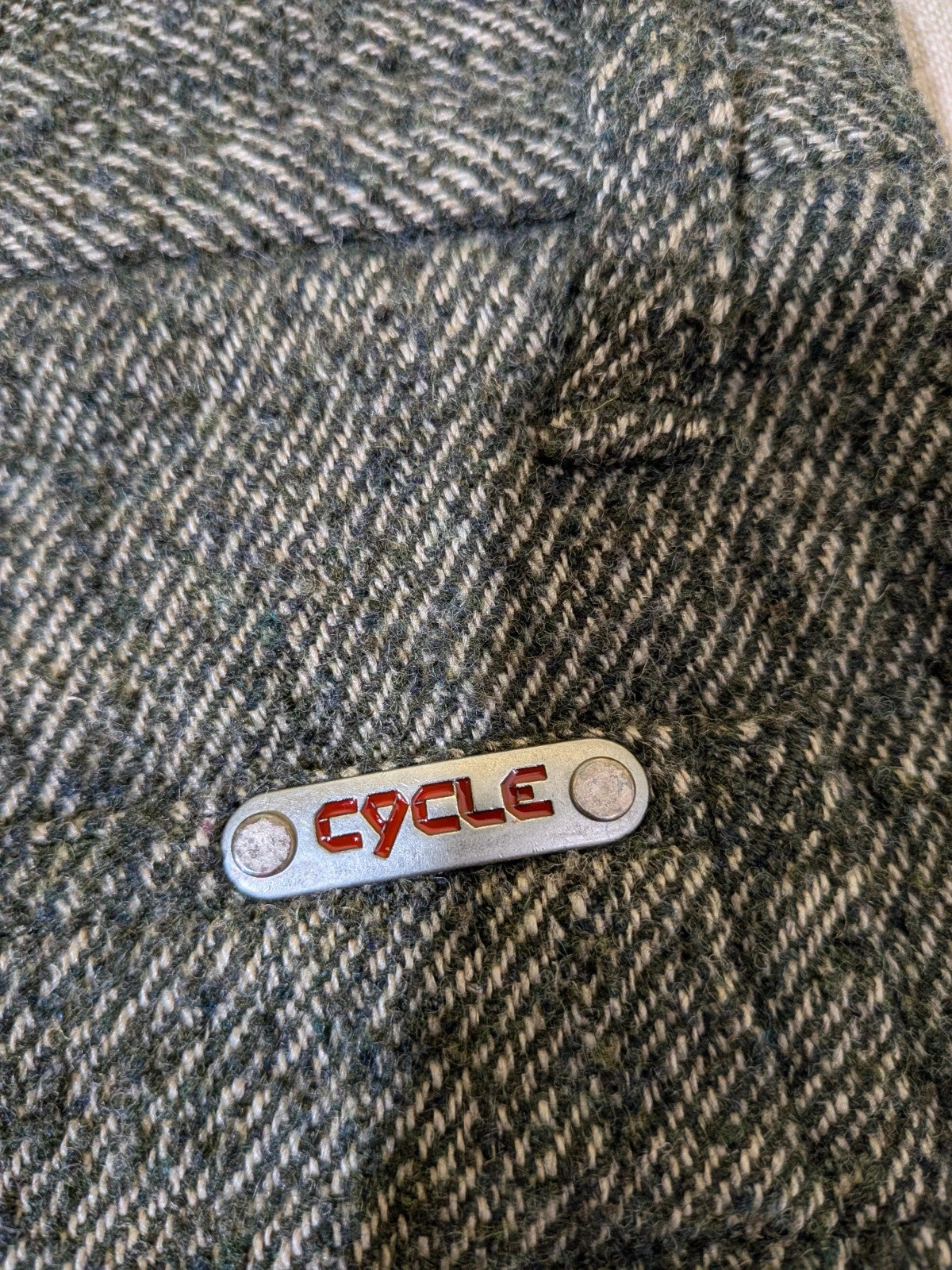 Cycle multi suit with tweed shorts and cream cropped sweater featuring distressed knit details.