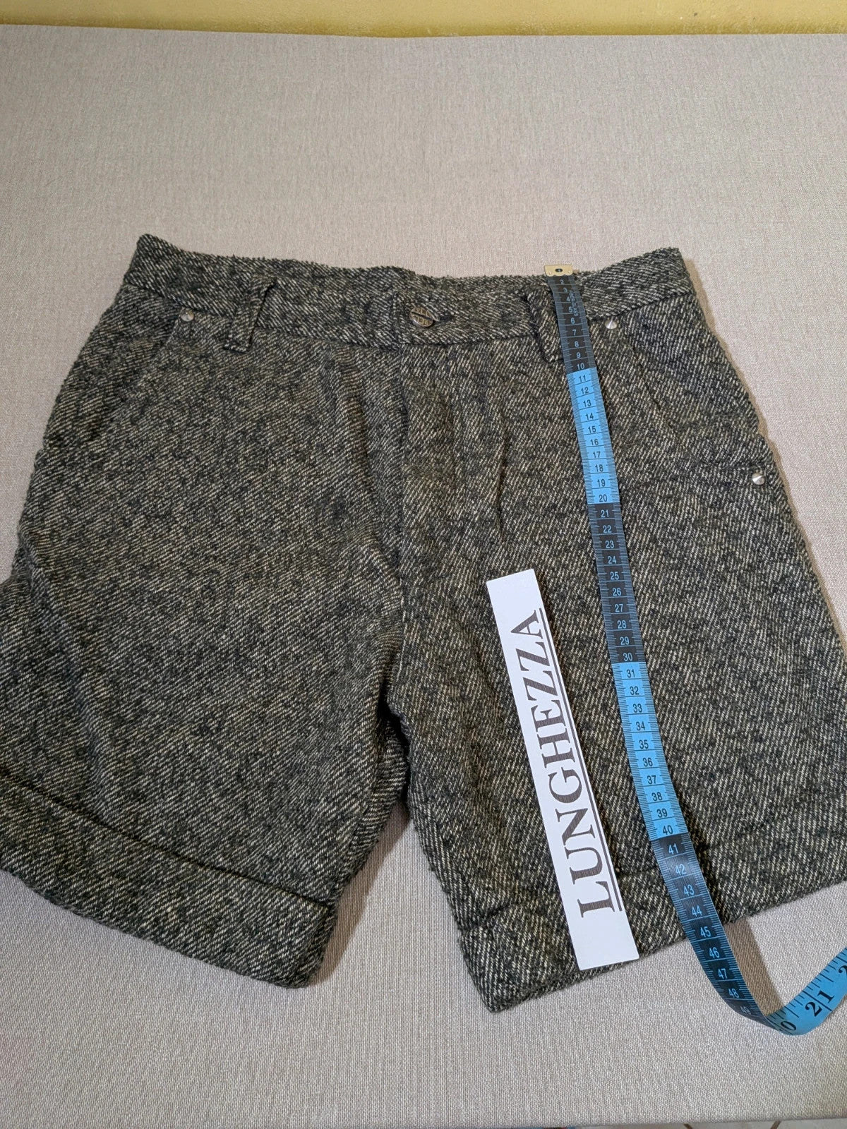 Cycle multi suit with tweed shorts and cream cropped sweater featuring distressed knit details.
