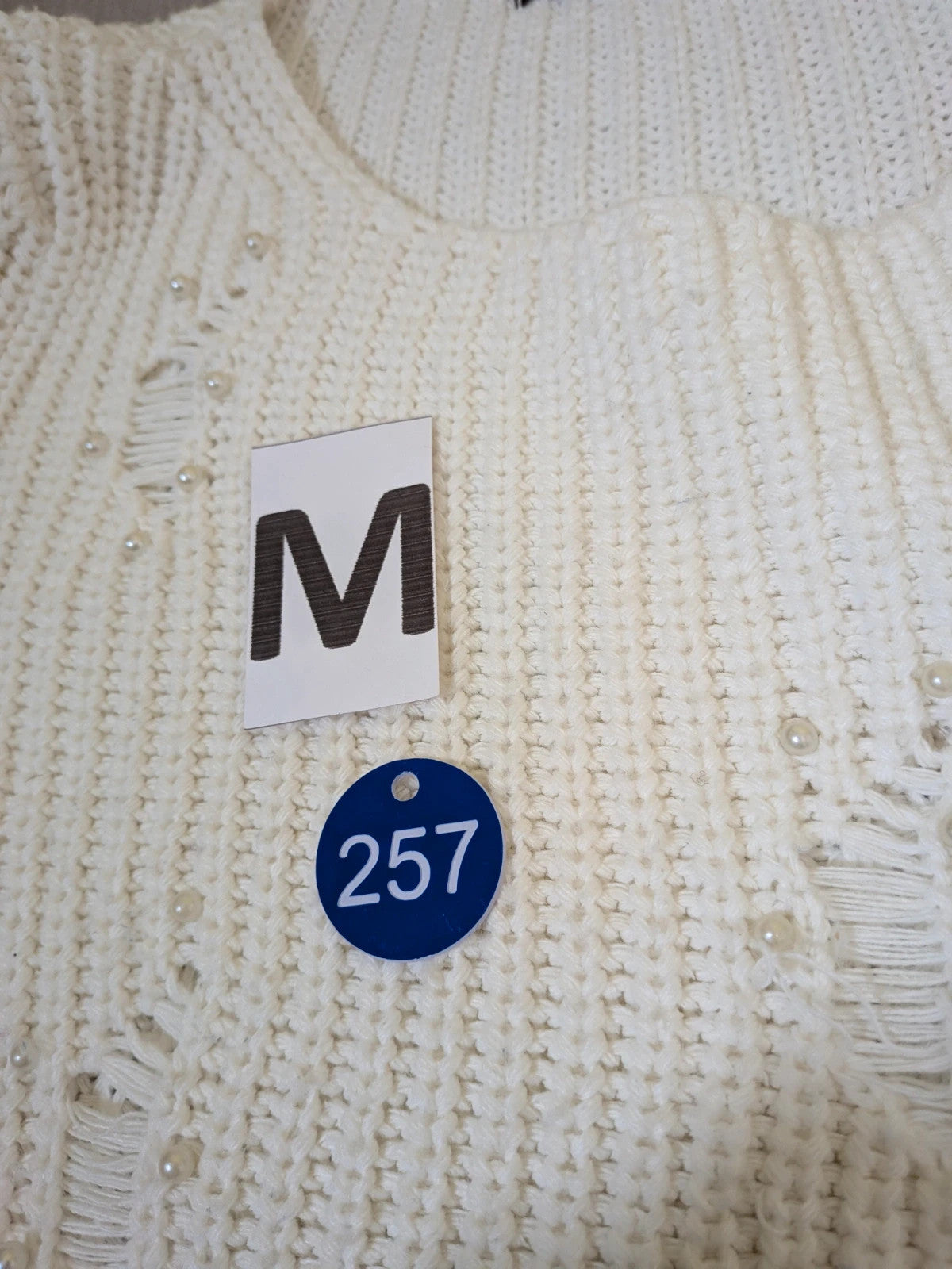 Cycle multi suit with tweed shorts and cream cropped sweater featuring distressed knit details.