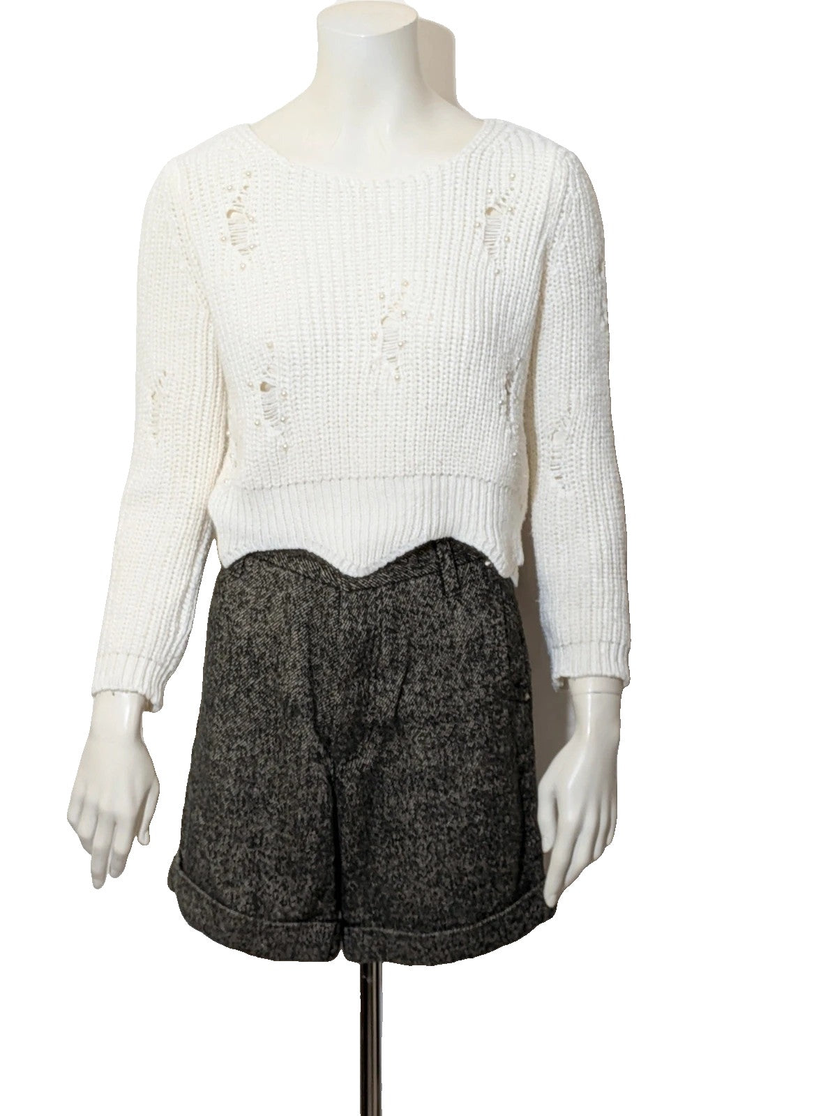 Cycle multi suit with tweed shorts and cream cropped sweater featuring distressed knit details.
