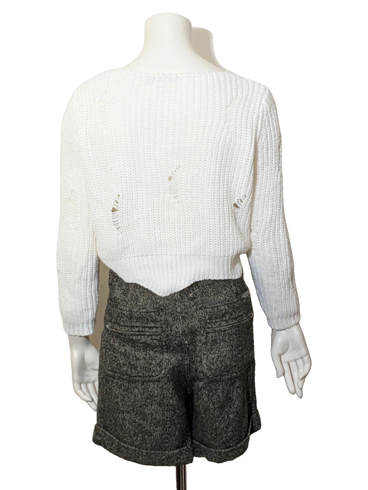 Cycle multi suit with tweed shorts and cream cropped sweater featuring distressed knit details.