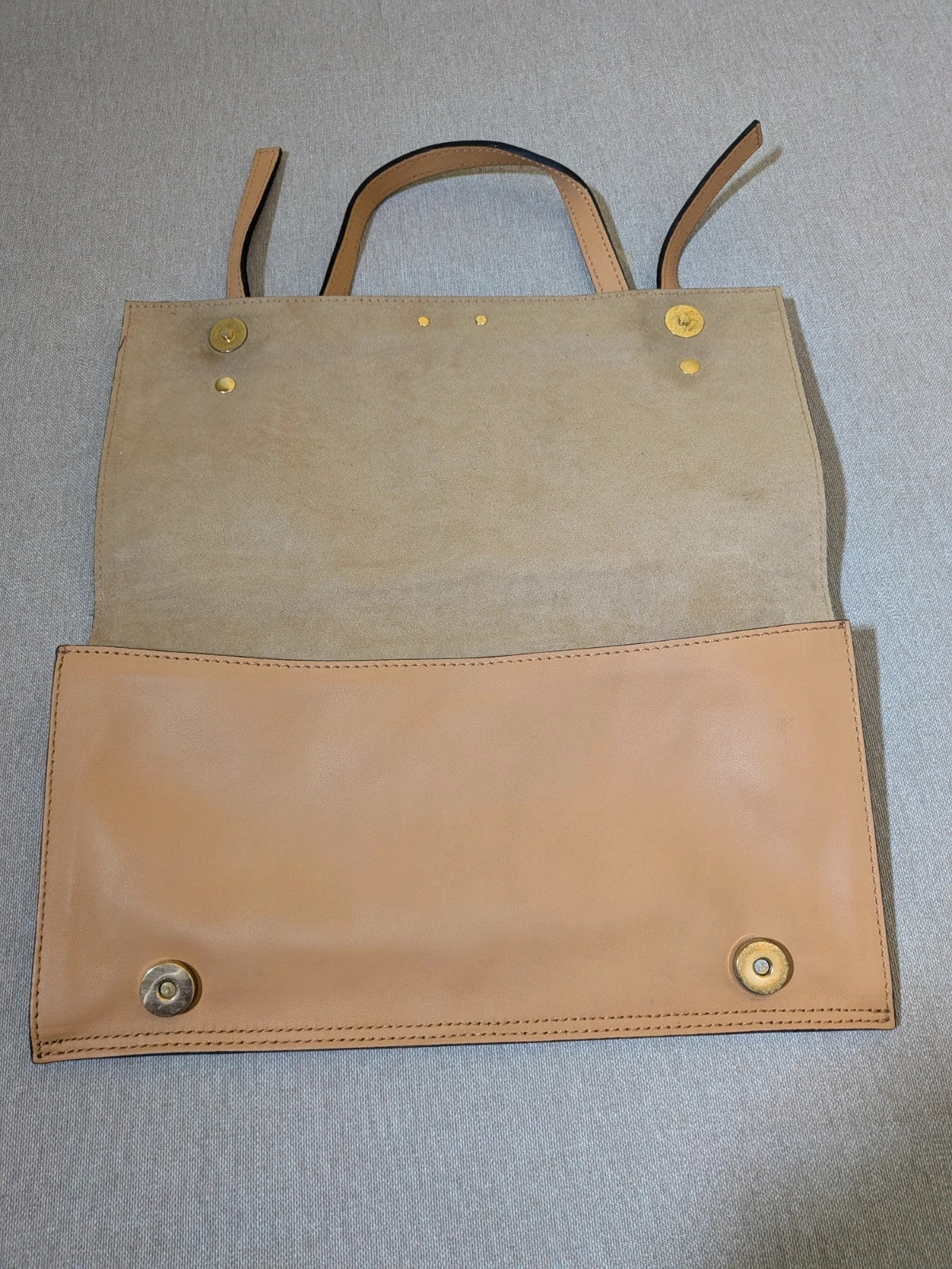 Innuè beige genuine leather shoulder bag with gold hardware and decorative buckles.