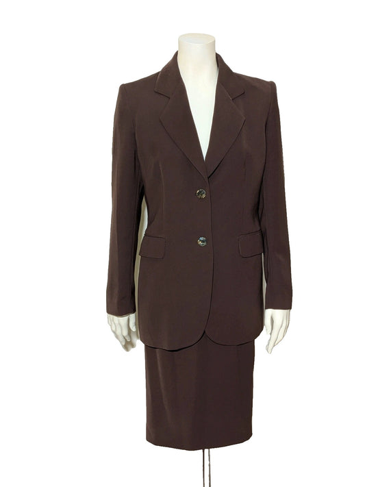 Selene brown skirt suit with tailored jacket, tortoiseshell buttons, and classic straight skirt.
