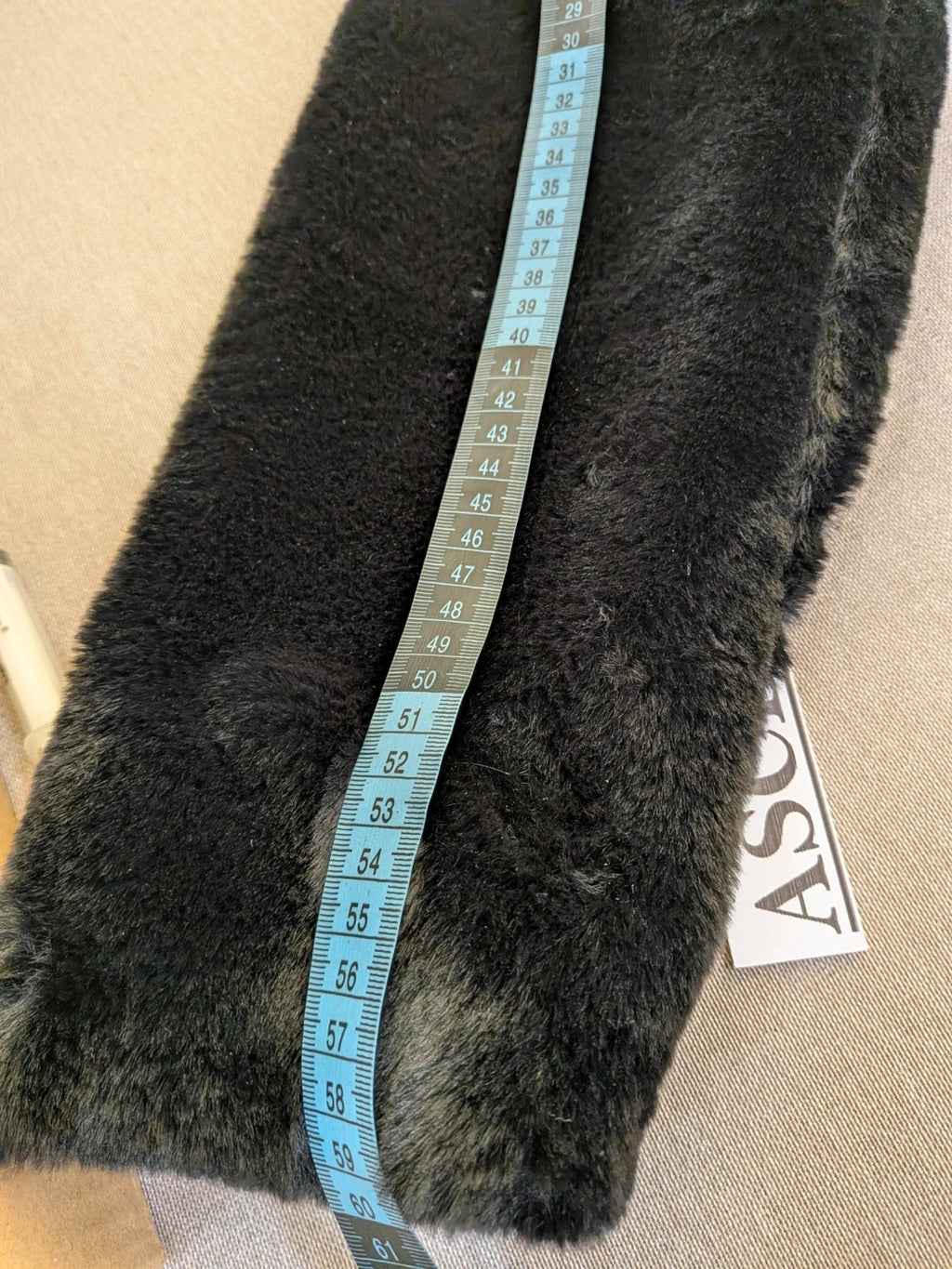 Zuiki black teddy coat with wide lapel, side pockets, and soft faux fur material.